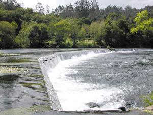 a waterfall in the middle of a river at Albergue Pensión Flavia in Padrón