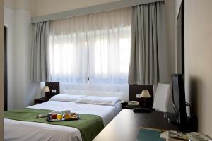 Postel nebo postele na pokoji v ubytování Dipendenza Hotel Bellavista