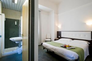 A bed or beds in a room at Dipendenza Hotel Bellavista