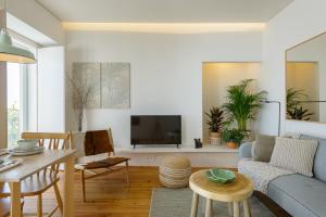 a living room with a couch and a tv at Dona Graca Lisbon Apartments in Lisbon