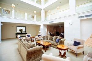 a large living room with couches and a table at Pontos Plaza Hotel in Essentuki