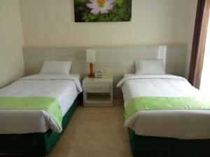 Кровать или кровати в номере Green Garden Hotel