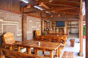 a dining room with wooden tables and chairs at Nadejda Hotel in Sofia