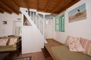 a living room with a staircase and a couch at Villa Petros in Symi