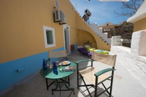 a small table and two chairs on a balcony at Villa Petros in Symi +2 photos