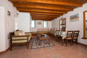 a living room with a couch and a table at Villa Petros in Symi