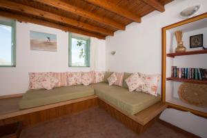 a living room with a couch and windows at Villa Petros in Symi