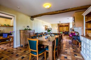 a dining room with a wooden table and chairs at Auberge de Smockelaer in Heijenrath +38 photos