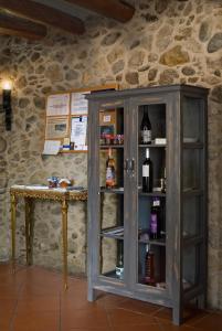 a wooden cabinet with wine bottles in it at Casa Rural El Pati de l´Albera in Sant Climent Sescebes