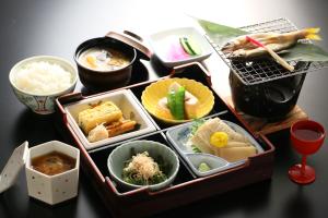 a table topped with trays of different types of food at Nanaeyae in Nikko