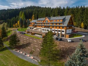 an aerial view of a large building with a yard at Grandhotel Tatra in Velké Karlovice