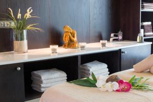 a bathroom with a sink and a table with towels at Hipotels Playa La Barrosa - Adults Only in Chiclana de la Frontera