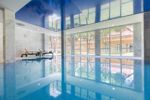 a swimming pool with a table in a building at Hipotels Playa La Barrosa - Adults Only in Chiclana de la Frontera