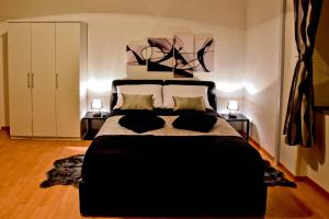 a bedroom with a large bed with two night stands at Studio L&D in Zadar