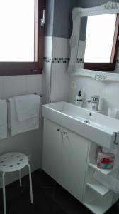 a white bathroom with a sink and a window at Ferienwohnung Belle Vue in Bernkastel-Kues +13 photos
