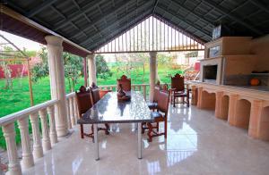 a screened in porch with a table and chairs at Green Garden Guest House in Tskaltubo