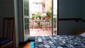 an open door to a patio with a table and chairs at Chiara Rooms in Rome