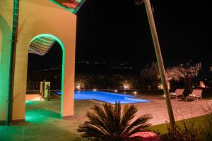 a building with a swimming pool at night at Villa Luxury House & Spa in Riva del Garda