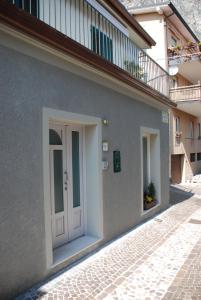 a white door on the side of a building at Casa Anita in Limone sul Garda