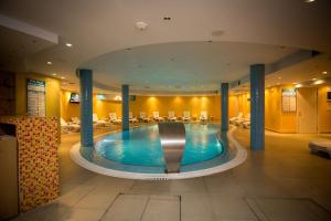 a large swimming pool in a hotel room at Hotel Colosseo & Spa in Shkodër