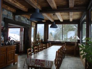 a large dining room with a table and chairs at Chambres d'Hôtes Chalet de la Source in Morillon