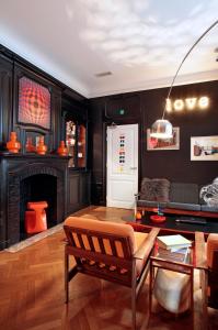 
a living room filled with furniture and a fireplace at Vintage Hotel Brussels in Brussels
