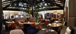 a restaurant with tables and chairs in a room at Librije's Hotel in Zwolle