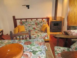 a living room with a couch and a fireplace at Casinha à beira ribeirio in Manteigas