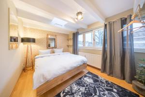 a bedroom with a large bed and a window at Design Apartments - "Potsdam City" , 19 in Potsdam
