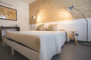 Ένα ή περισσότερα κρεβάτια σε δωμάτιο στο Bed and breakfast Aratro & Rosmarino