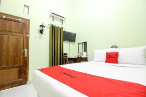Rúm í herbergi á RedDoorz Plus near Taman Sari