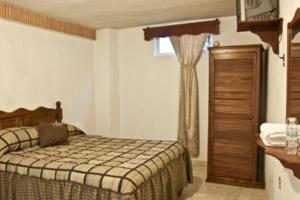 Un pat sau paturi într-o cameră la Hotel Don Porfirio