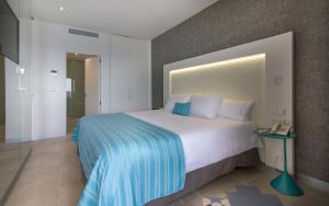 a bedroom with a large bed and a phone at ESTIMAR Calpe Suitopia in Calpe
