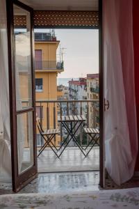 an open door to a balcony with a table at B&B Posidonia Salerno in Salerno