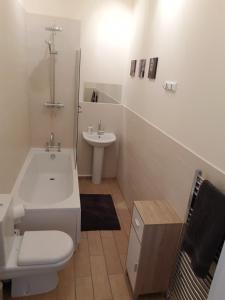 Baño blanco con lavabo y aseo en Tunstall Serviced Home, en Sunderland