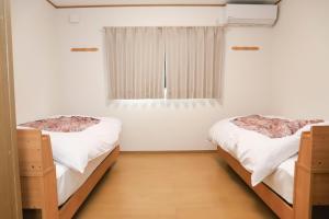 Łóżko lub łóżka w pokoju w obiekcie Guest House En