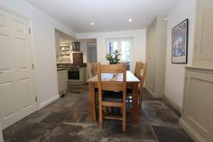 a kitchen with a dining room table and chairs at Binswood Garden Apartment in Leamington Spa
