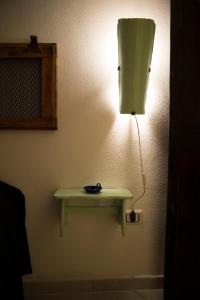 
a lamp is hanging on a wall next to a wall at A mi Manera in Sassari
