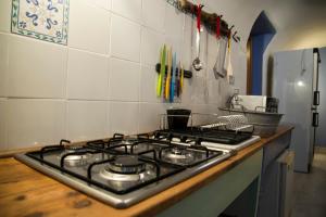 
a white stove top oven sitting under a counter top at A mi Manera in Sassari
