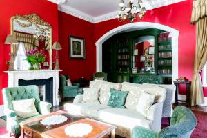 a living room with red walls and a white couch at Butlers Townhouse in Dublin