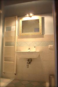 a bathroom with a sink and a mirror at Affittacamere La Loggia in Altopascio