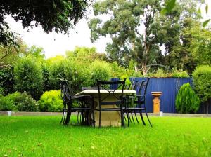 a wooden bench sitting in front of a lush green field at Otway Gate Motel in Colac