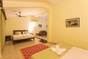 Postel nebo postele na pokoji v ubytování Hotel Coorg International