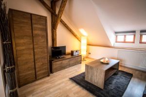 a living room with a large wooden sliding door at Tylova Apartments in Kutná Hora