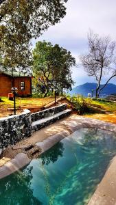 a large pool of water in front of a house at Cottage in front of the sea in Bonassola