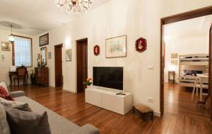 a living room with a large television and a couch at Ve-nice Suite Rio Marin SC847 in Venice