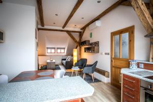 a kitchen and living room with a table and chairs at Tylova Apartments in Kutná Hora