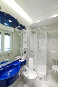a bathroom with a blue sink and a shower at Mastino Rooms in Verona