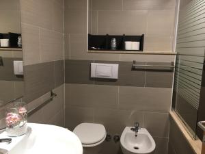 a bathroom with a toilet and a sink at Hotel Corallo in Fregene