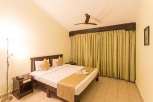 Postel nebo postele na pokoji v ubytování Hotel Coorg International